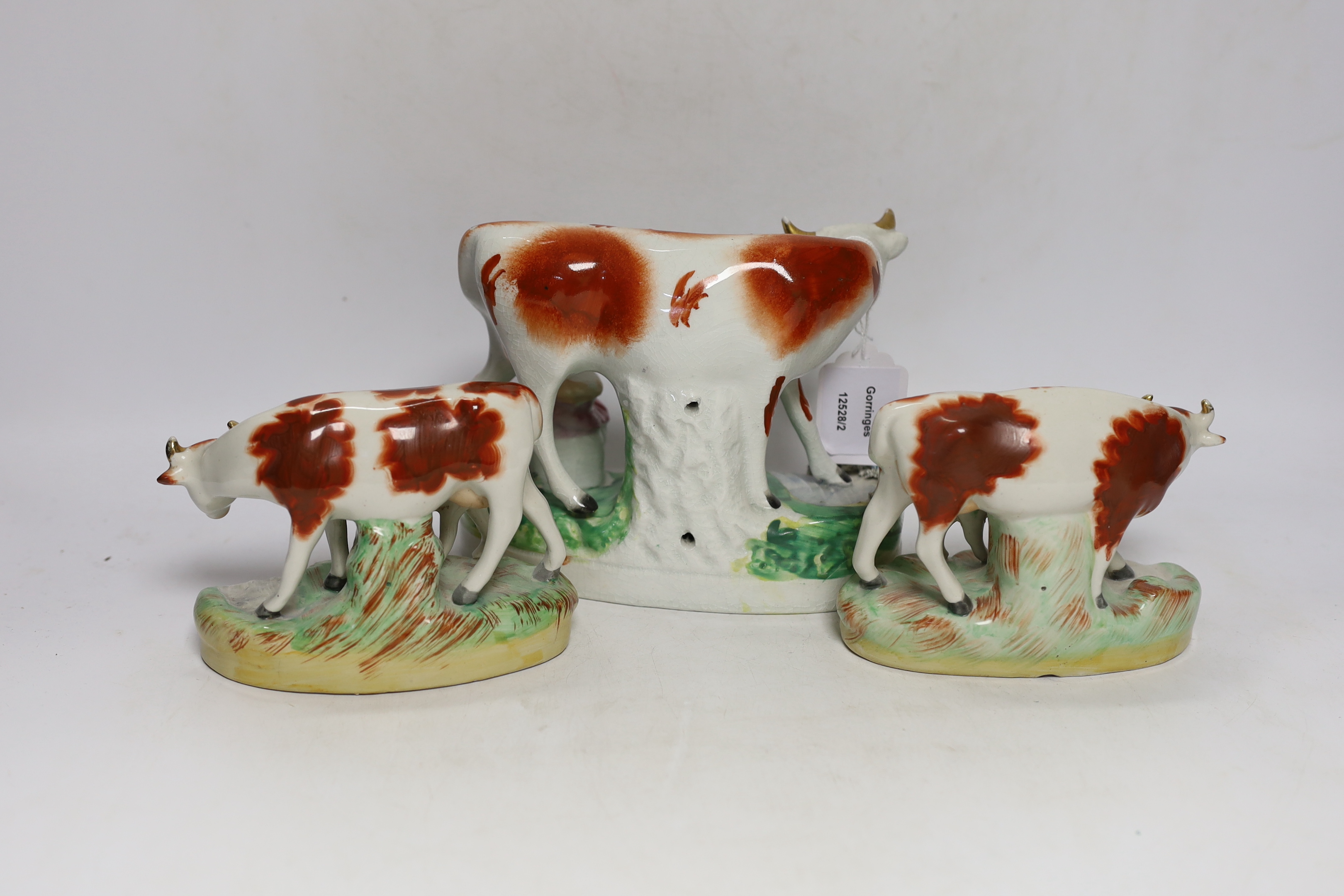 Three Victorian Staffordshire cow groups, tallest 15cm high